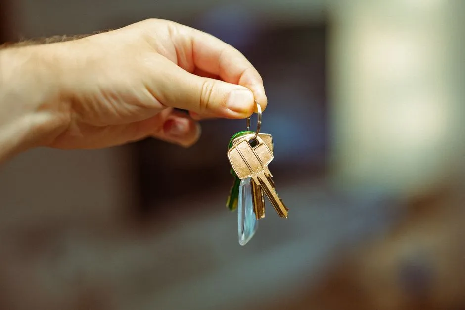 Close-up of a hand holding a set of apartment keys